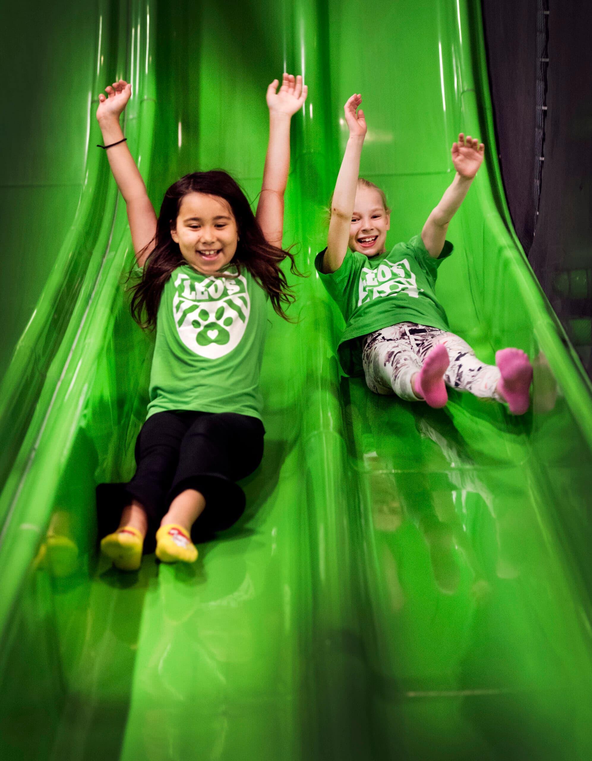 Children sliding down a slide at Sport Club