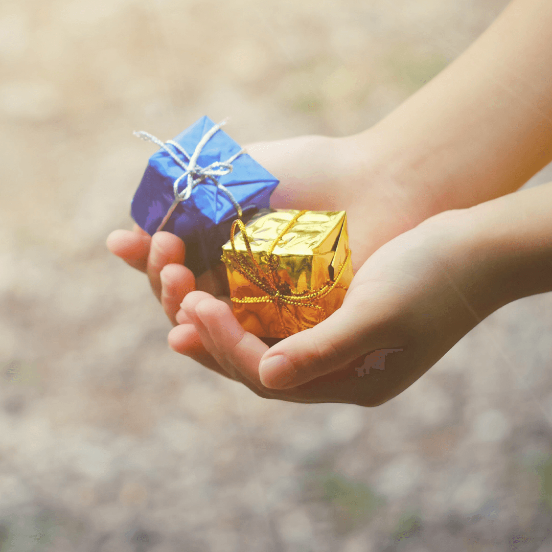 Child holding two small treasure gifts – fun birthday games for kids like treasure hunts bring excitement and smiles.
