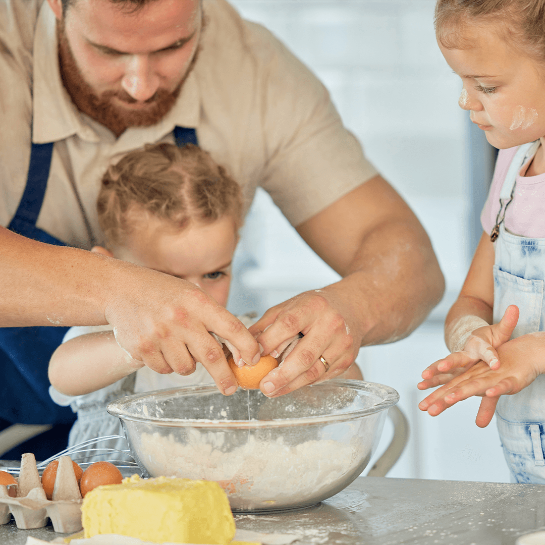 Dad and kids baking together – fun things to do with kids on a rainy day.
