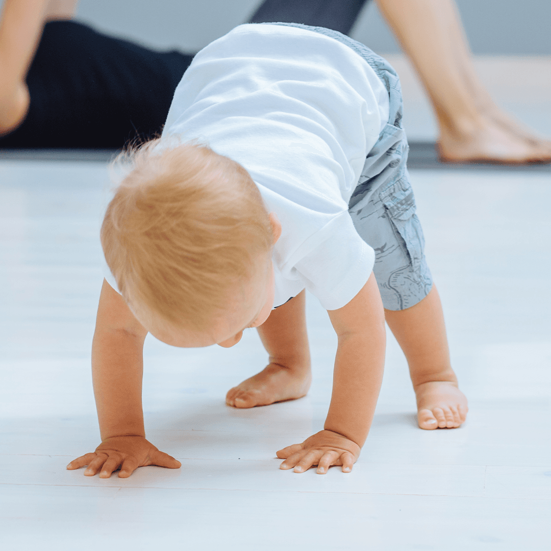 Baby practicing bear crawl, early motor skill development through movement for kids