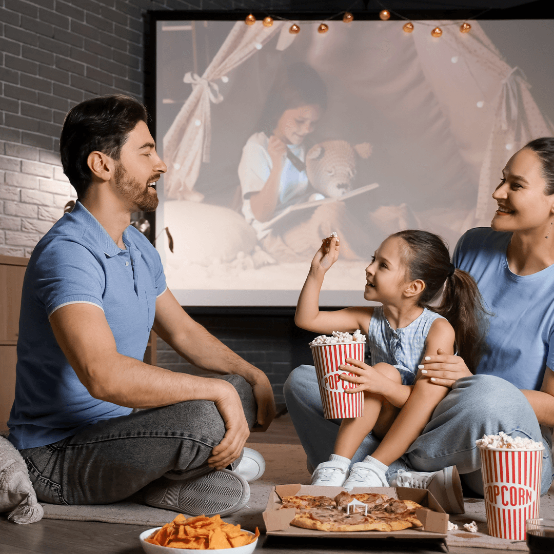 Family enjoying movie snacks at home – cozy rainy day activities with kids.