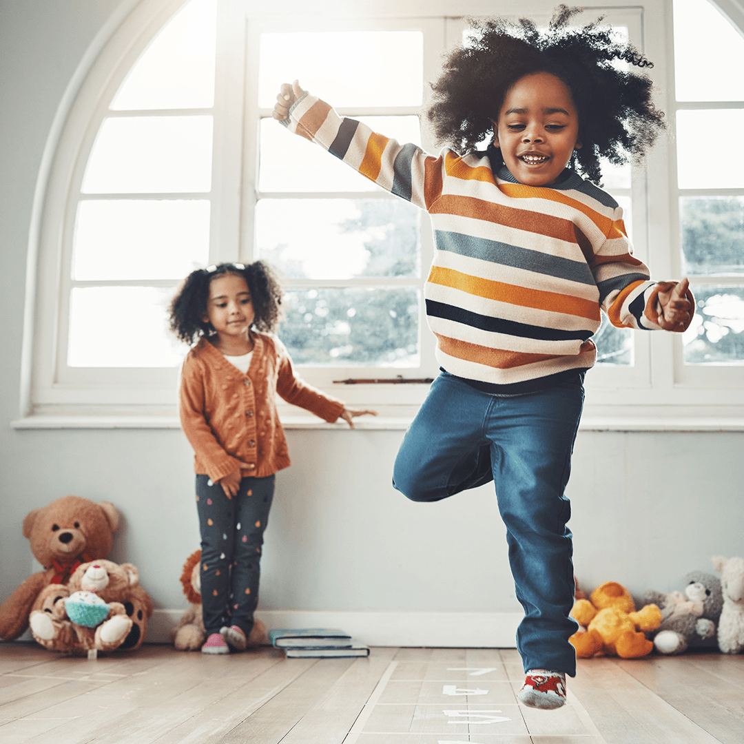 Child hopping on one foot to build balance, movement for kids