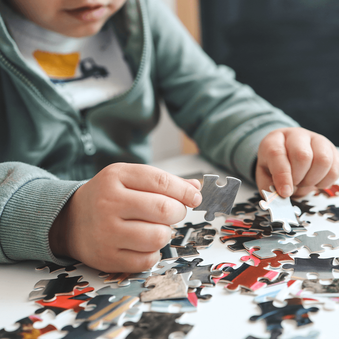 Child doing puzzle, movement for kids supports fine motor skills